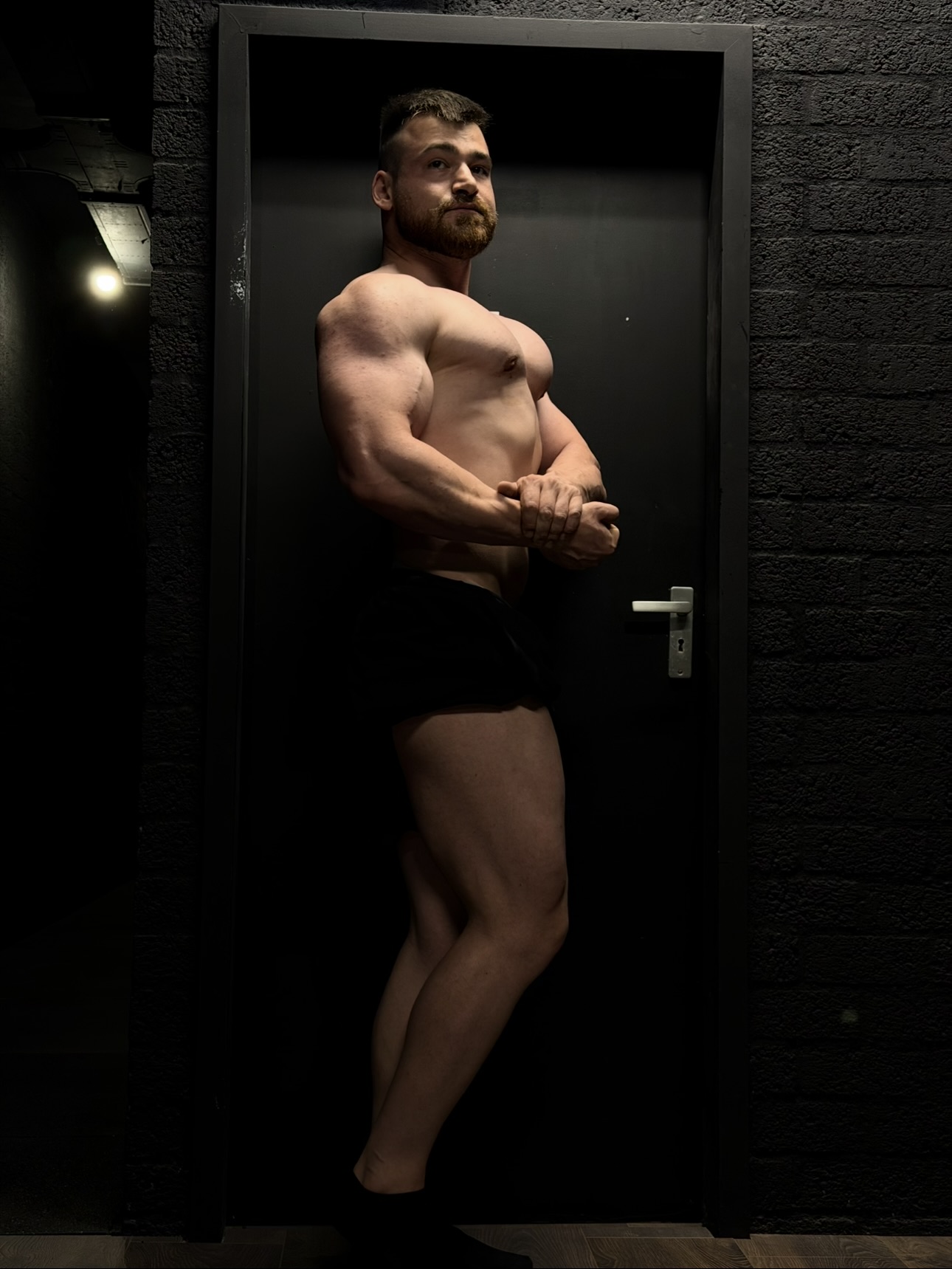 Artjom posing in a dark gym
